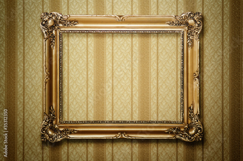 Grunge gold wooden frame on striped wallpaper with clipping path photo