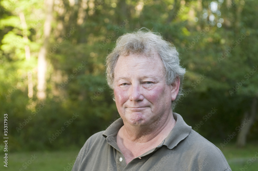 middle age senior man in suburban backyard