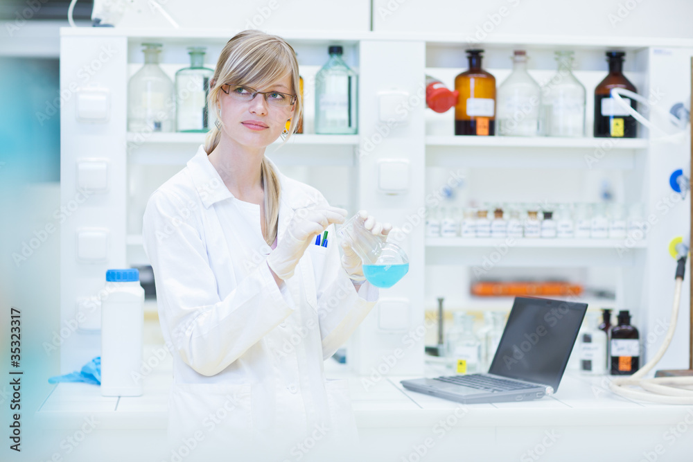 female researcher carrying out research in a lab female researcher carrying out research in a lab