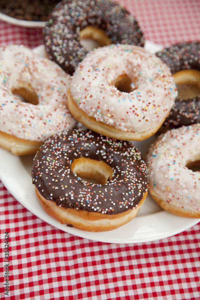 A couple of donuts on table. A couple of donuts on table.