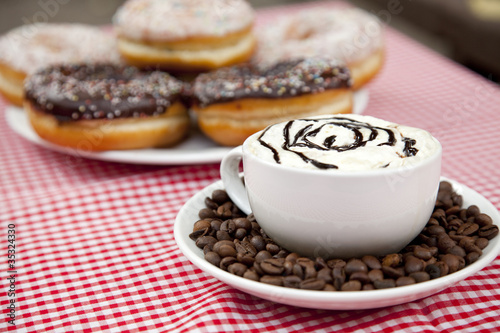 donuts with coffee on table.