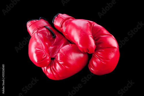 Red boxing gloves isolated on black