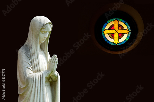 Isolated statue of Mary with cross