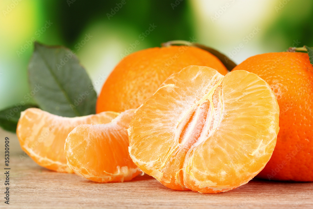 Juicy ripe tangerines with cloves on wooden table outdoors Juicy ripe tangerines with cloves on wooden table outdoors