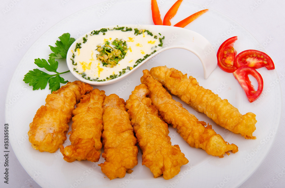 Battered chicken served with sauce Battered chicken served with sauce