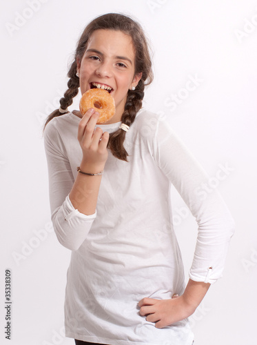Happy Young Girl eating donut