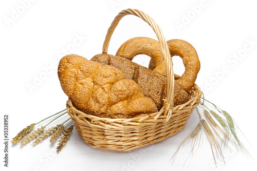 Basket with bread on white background