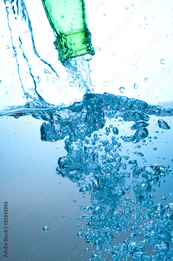 Green bottle and water splashing Green bottle and water splashing