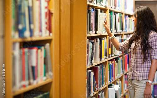 Young woman choosing a book