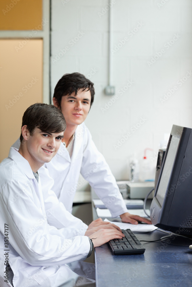 Portrait of scientists posing with a monitor