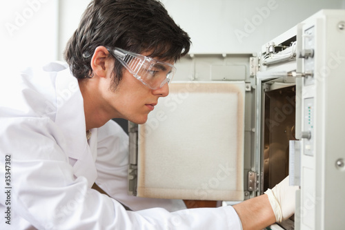 Fotografie Close up of a scientist using a laboratory chamber furnace
