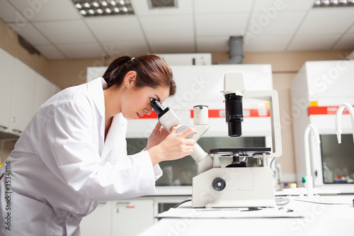Female scientist looking in a microscope