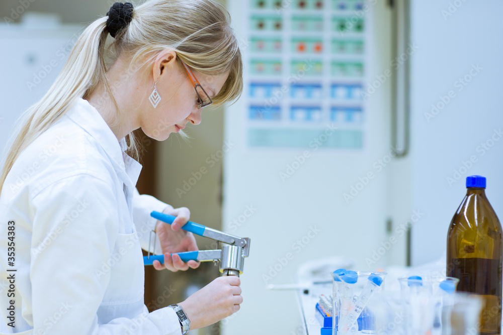 Fototapeta premium female researcher carrying out research experiments in a lab