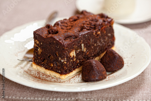 Dark chocolate cake and chocolate truffles on a plate