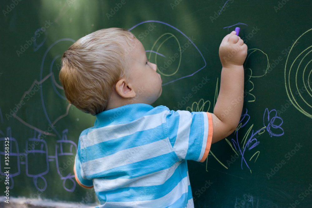 Boy drawing with chalk