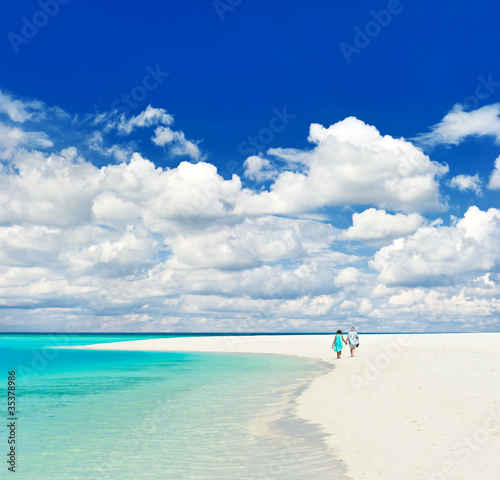 beautiful tropical landscape. senior couple walking on a beach