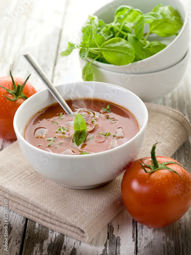 tomato soup with basil leaf on bowl