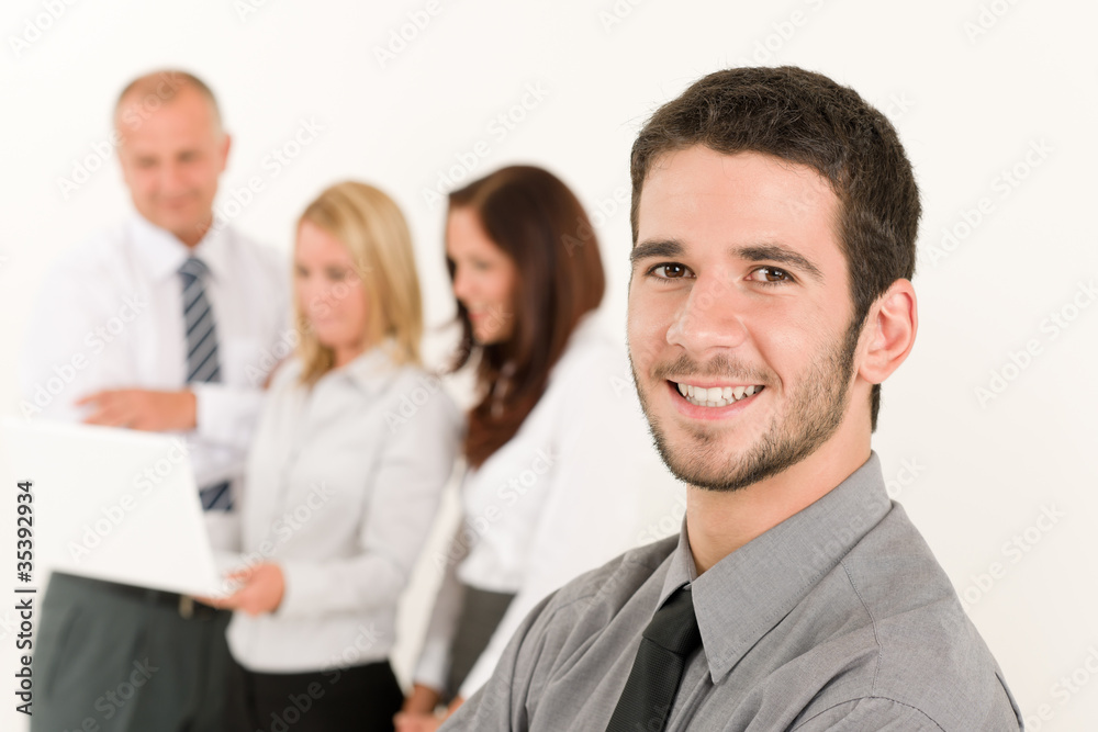 Businessman handsome with colleagues in the back