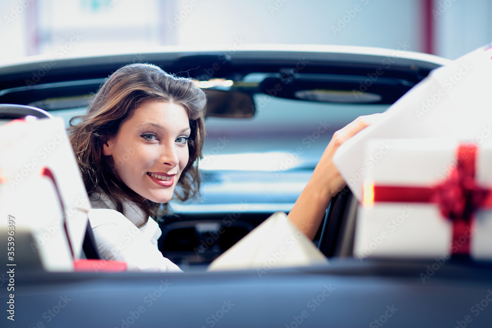 portrait of young woman, shopping, convertible car, gift box