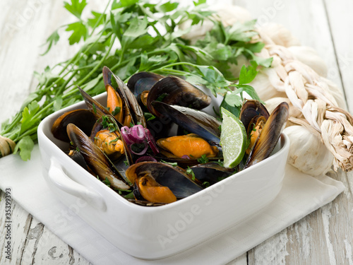 mussel soup on bowl with parsley and garlic