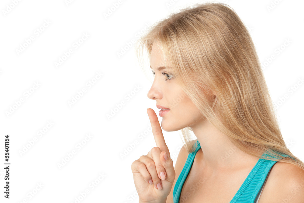 Side view of young woman with finger on lips Side view of young woman with finger on lips