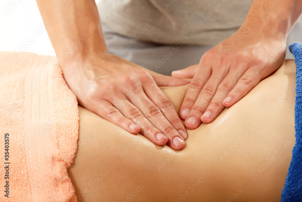 masseur makes belly massage young woman isolated on white