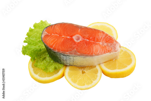 Salmon steak with greens and lemon isolated