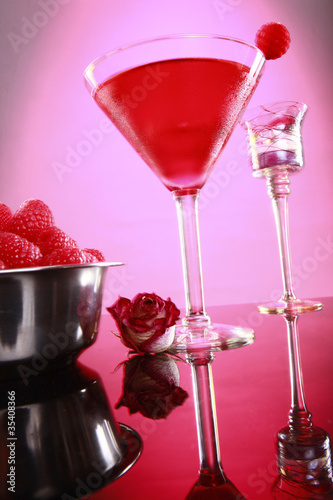 Cosmopolitan coktail and raspberry on pink