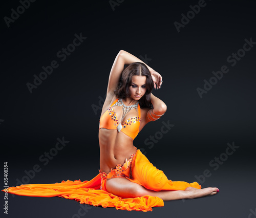 beauty naked dancer posing in orange veil