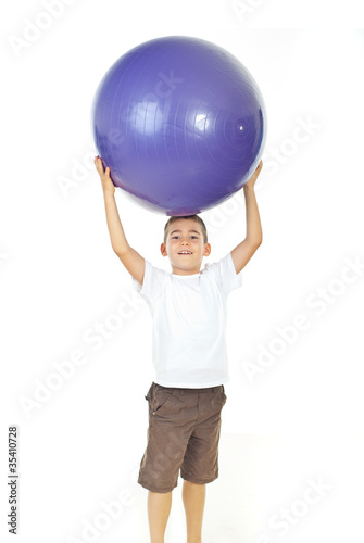 Boy holding big ball over head © Gabriel Blaj