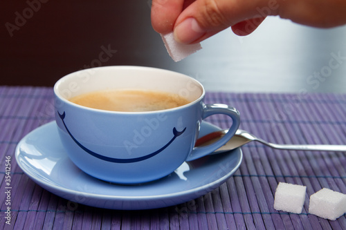 Cup of coffee on the purple table mat