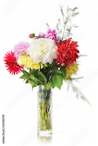 Bouquet of flowers in a crystal vase on white background