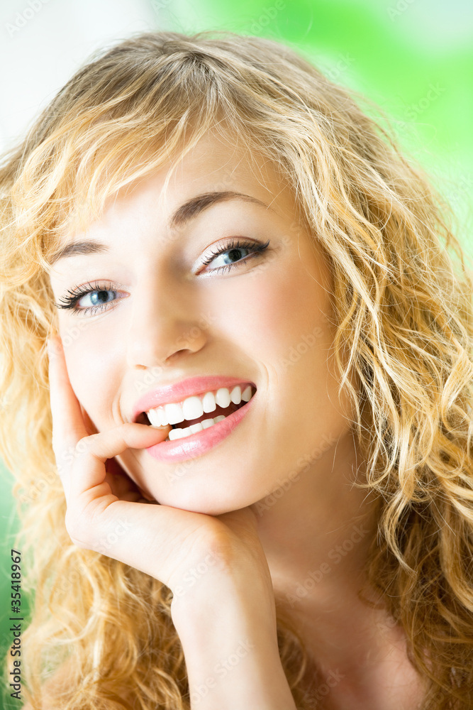 Portrait of thinking young woman, indoors