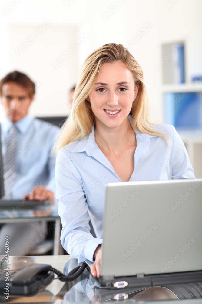 Beautiful woman in office working on laptop computer Beautiful woman in office working on laptop computer
