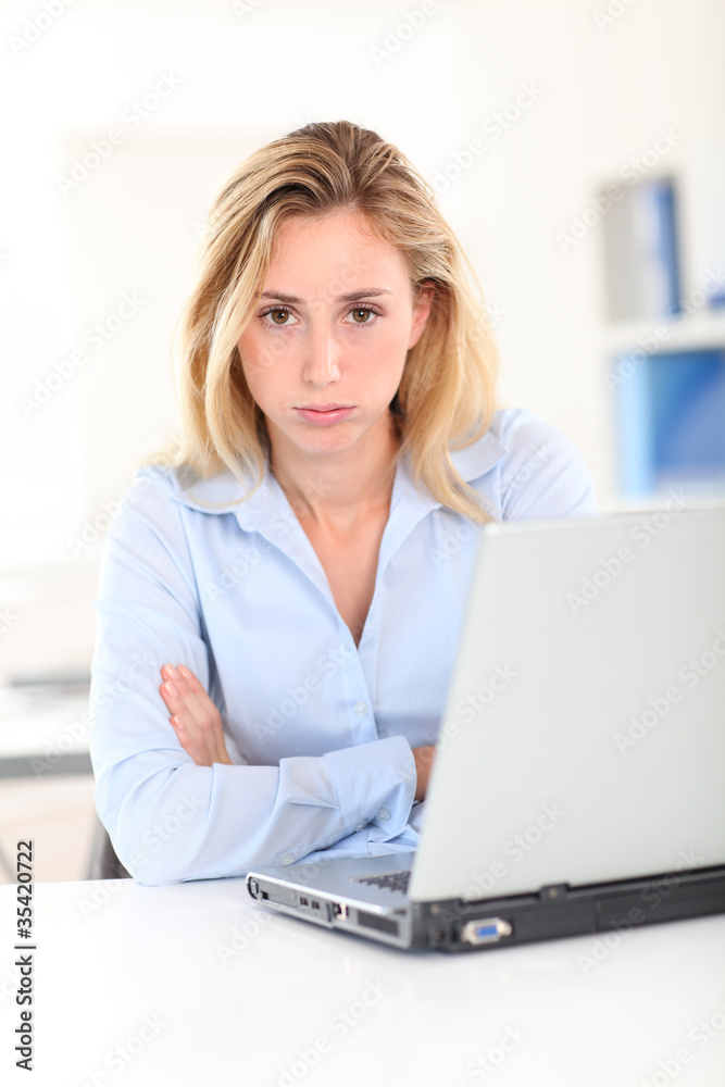 Office worker with bored look on her face Office worker with bored look on her face