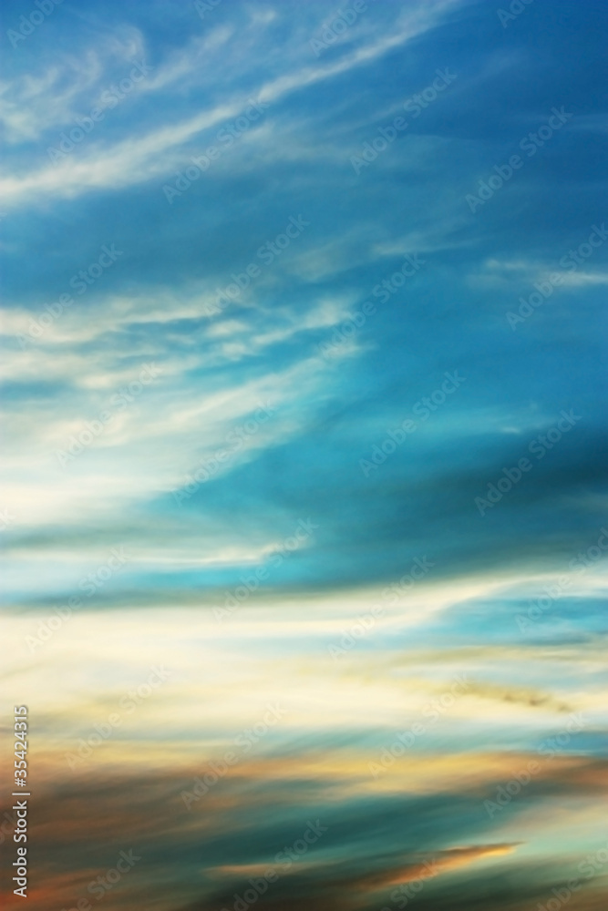 Sky blue background with wispy clouds