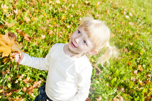 portrait of little girl in autumnal nature
