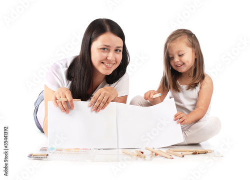Young mom and her small daughter draw pencils. Isolated on white