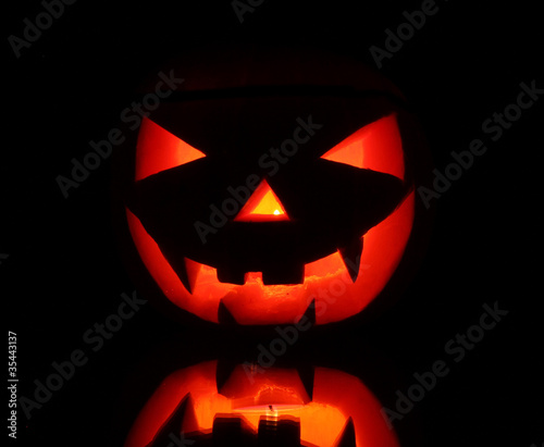 Halloween pumpkin evil face in darkness