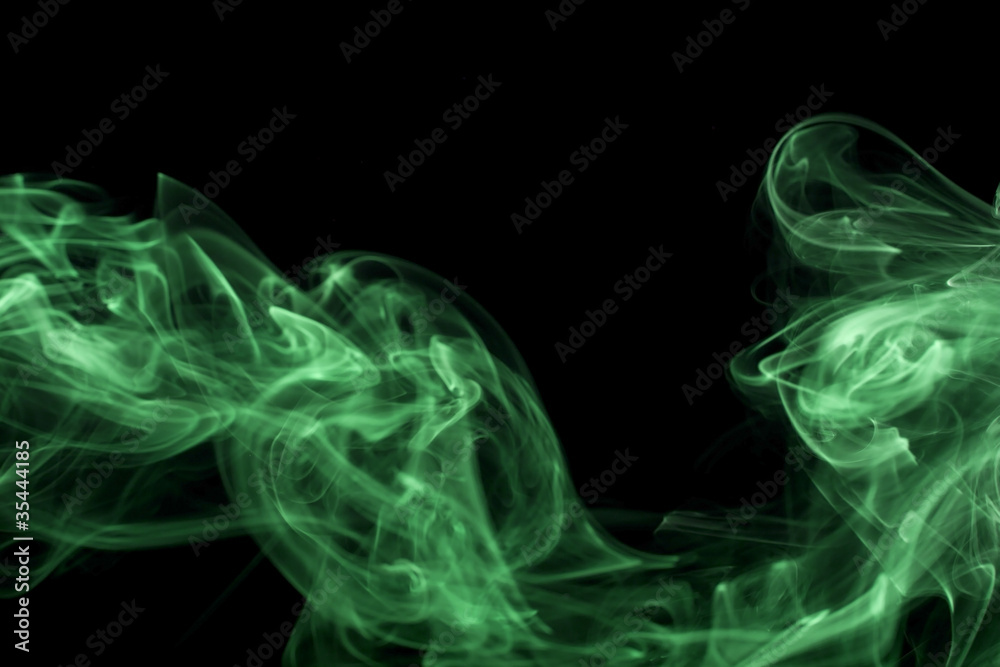 Abstract green colored smoke, black background.