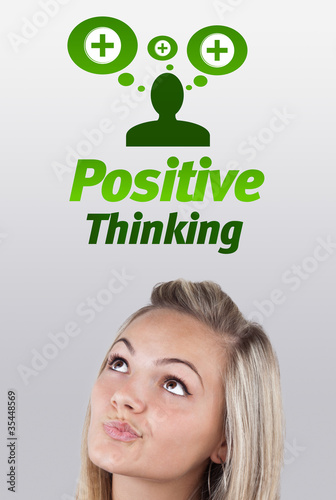 Young girl looking at positive negative signs photo