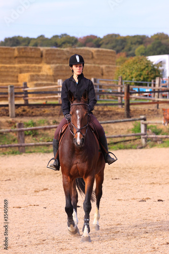 pretty young woman rider in a competition riding