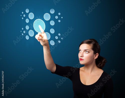 Businesswoman pressing high tech type of modern buttons © ra2 studio