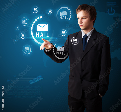 Businessman pressing virtual messaging type of icons