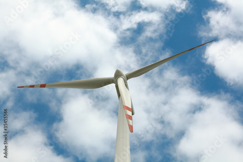Wind turbine on blue sky © wajan