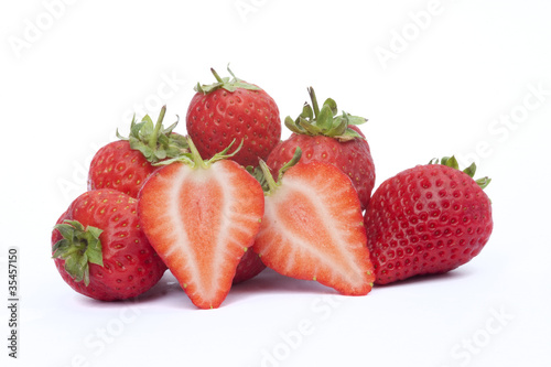 Fresh sliced strawberries isolated on white background