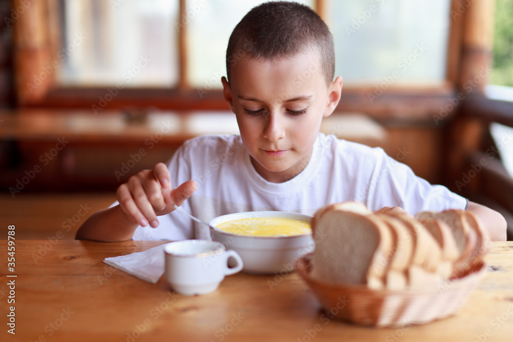 Child eating soup in a restaurant