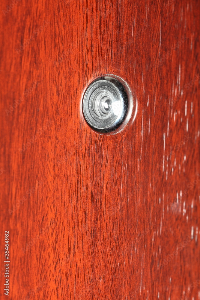 Peephole on wooden door Peephole on wooden door