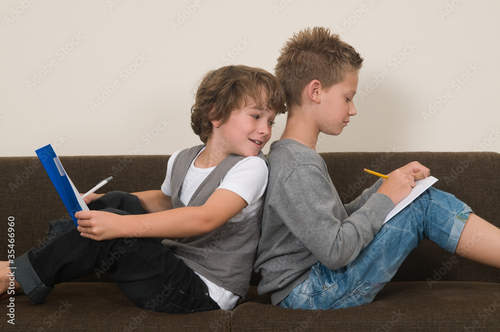 Doing homework on the couch Doing homework on the couch
