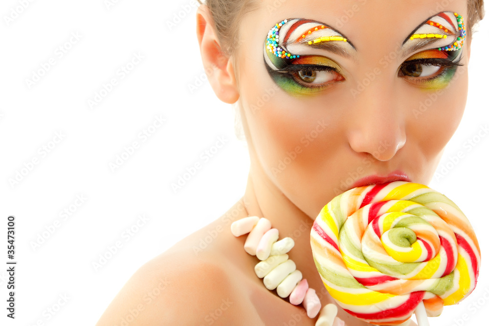 Naklejka premium woman licks candy with beautiful make-up isolated on white
